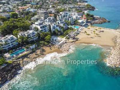 an aerial view of a beach and buildings at Infiniti Blu, Sosua in Sosúa