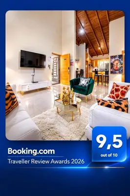 a living room with two couches and a tv at Luxury Sky Blue in Jarabacoa