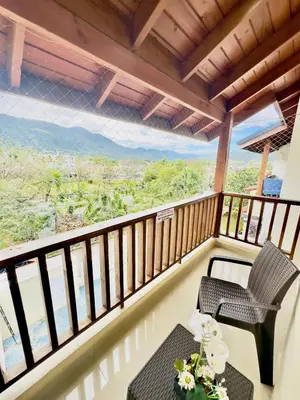 a balcony with a table and chairs and a view at Luxury Sky Blue in Jarabacoa