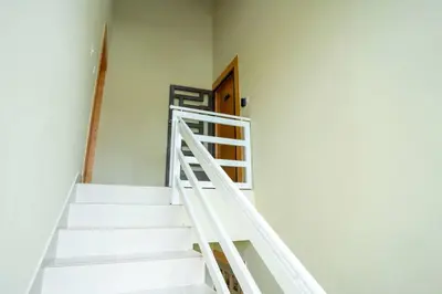 a white staircase in a room with a door at Luxury Sky Blue in Jarabacoa