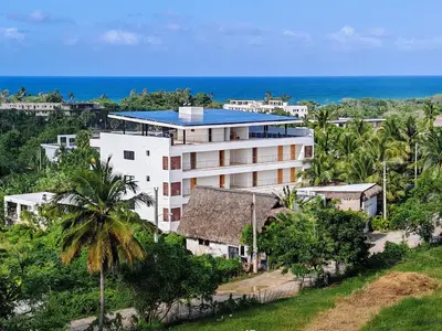 an aerial view of a building with the ocean in the background at Surf One in Sosúa