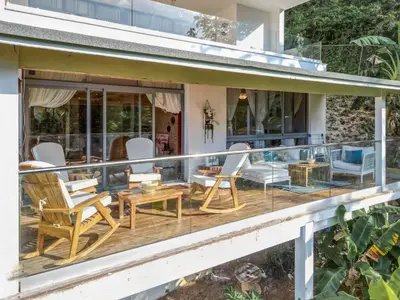 a deck with chairs and tables on a house at Villa loren A3 in Las Terrenas