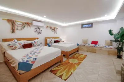 a bedroom with two beds and a couch at Villa loren A3 in Las Terrenas
