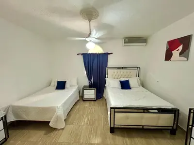 a bedroom with two beds and a ceiling fan at Casa Tipo Villa, Piscina, Playas De RSJ a 4 min in Río San Juan