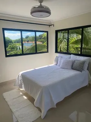 a bedroom with a large bed with two large windows at Apartamento con agua caliente para 9 personas in La Ureña