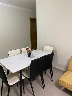 a white table with chairs and a vase of flowers on it at Apartamento con agua caliente para 9 personas in La Ureña