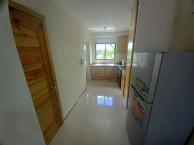 a kitchen with a stainless steel refrigerator and a window at Apartamento con agua caliente para 9 personas in La Ureña