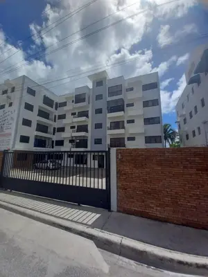 a white building with a fence in front of it at Apartamento con agua caliente para 9 personas in La Ureña