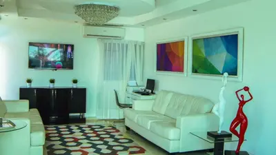 a living room with a white couch and a desk at Dpravia Hotel SRL in Baní