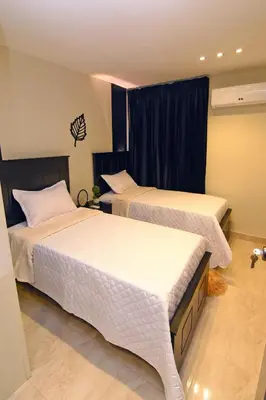 two beds sitting in a room with a window at Solmi Rooms in Calero