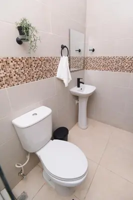 a bathroom with a toilet and a sink at Solmi Rooms in Calero
