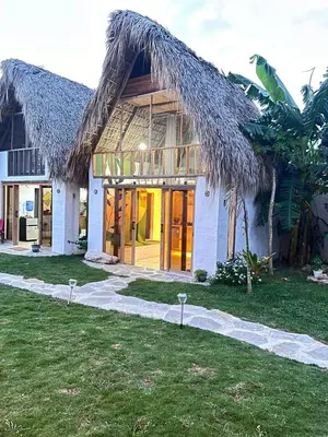 a building with a thatched roof at Blue Beach Eco-Hotel by Sanfabini in Bayahibe