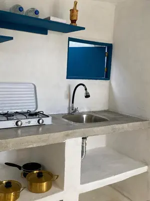 a kitchen counter with a sink and a stove at Blue Beach Eco-Hotel by Sanfabini in Bayahibe