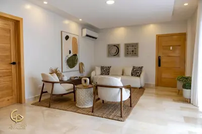 a living room with a couch and a table at Golden Penthouse by Amar'e in Las Terrenas