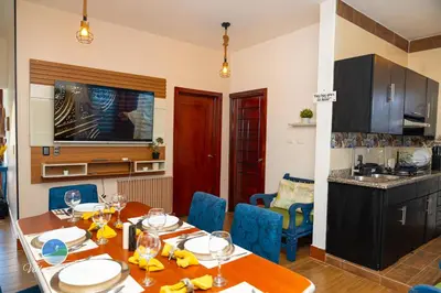 a kitchen and dining room with a table and chairs at Villa del Mar in Santa Cruz de Barahona