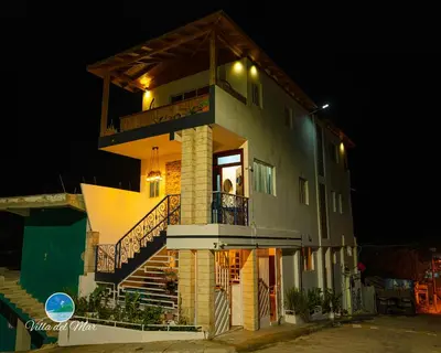 a large building with a balcony and lights on it at Villa del Mar in Santa Cruz de Barahona
