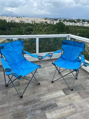 two blue chairs sitting on top of a balcony at Luxury Penthouse Santo Domingo W in Santo Domingo