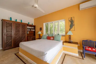 a bedroom with a large bed and a window at Villa Azulsalado - Frente a la playa in Las Terrenas