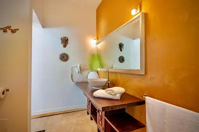 a bathroom with a sink and a mirror at Villa Azulsalado - Frente a la playa in Las Terrenas