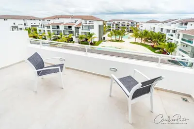 a balcony with two chairs and a view of the resort at Syrma 302 Estrella Dominicus Apartment in La Laguna