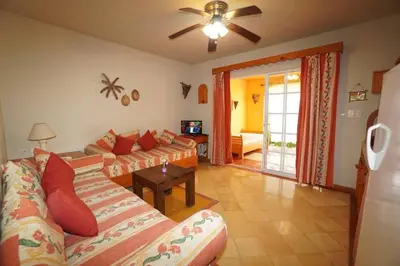 a living room with two couches and a ceiling fan at Villa Playa Bonita, Pool, Tropical Gardens in Las Terrenas