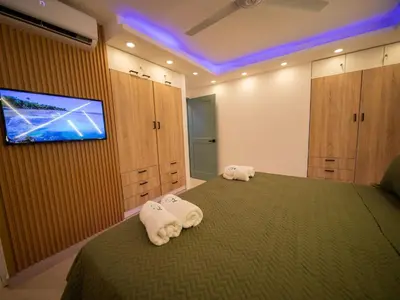 a bedroom with a bed with towels on it at Garden Condos 5- Luxurious Apartment In Sosua Center in Sosúa