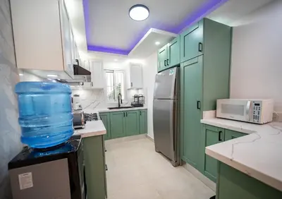 a kitchen with green cabinets and a blue ceiling at Garden Condos 5- Luxurious Apartment In Sosua Center in Sosúa
