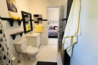 a bathroom with a toilet and a sink and a shower at Residencial Tropimar Sosua in Sosúa