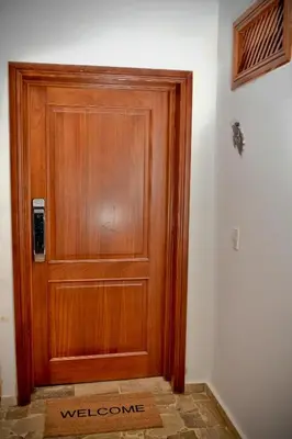a wooden door with a welcome mat in front of it at White Sands Punta Cana - Pool-Jacuzzi in Punta Cana