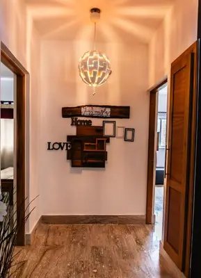 a hallway with a chandelier on the wall at Departamento en las Terrenas a pie de Playa in Las Terrenas
