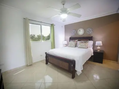 a bedroom with a large bed and a window at Garden Condos Apt 35 - Affordable 1br Apt In Sosua in Sosúa