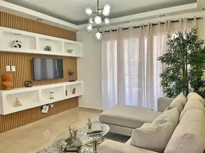 a living room with a couch and a tv at Apto 3 Habitaciones Zona Tranquila Con Parqueo in Concepción de La Vega
