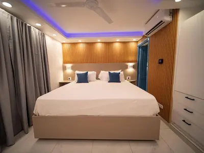 a bedroom with a large bed with blue lighting at Garden Condos 39, Luxury Apartment In Sosua Town in Sosúa