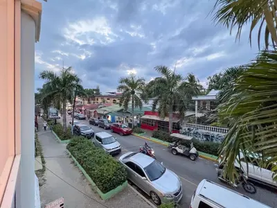 a street with cars parked on the side of the road at Plaza Achim 7, Luxury Apt 250m From Sosua Beach in Sosúa