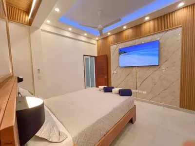 a bedroom with a bed and a tv on a wall at Plaza Achim 7, Luxury Apt 250m From Sosua Beach in Sosúa