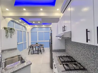 a kitchen with a sink and a stove top oven at Plaza Achim 7, Luxury Apt 250m From Sosua Beach in Sosúa
