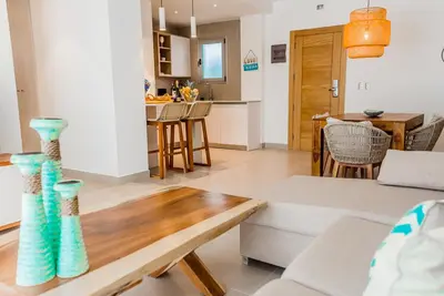 a living room with a couch and a table at Beach Homes Punta Cana in Punta Cana