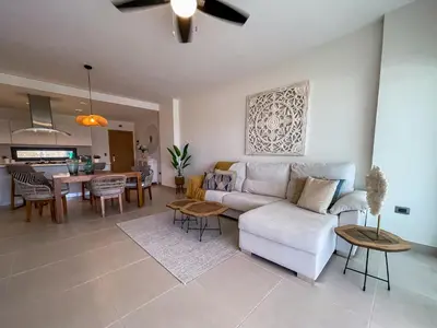 a living room with a white couch and a table at Beach Homes Punta Cana in Punta Cana