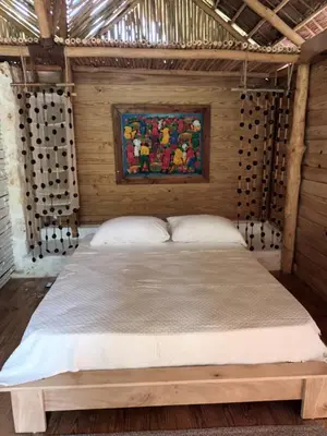 a bedroom with a bed in a wooden wall at Samo Eco Lodge in Las Terrenas