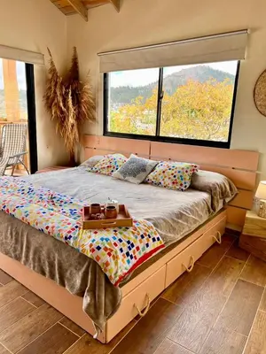 a bedroom with a large bed with a large window at El ATiCO ConstanzaRD in Constanza