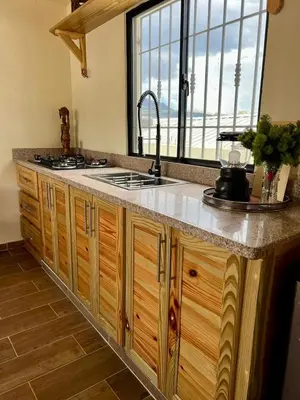 a kitchen with a sink and a counter with a window at El ATiCO ConstanzaRD in Constanza