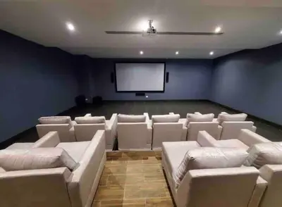 a cinema room with white couches and a screen at Brand New Luxury 1 BDR Pool-Cine - Saune-WIFI - I 19 in Santo Domingo