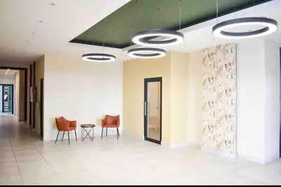 a hallway with chairs and a table in a building at Deluxe_Suite_1BDR_POOL_GYM_SAUNE in Santo Domingo