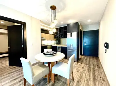 a kitchen with a table and chairs in a room at RoyalSuite 1BDR-Poll-Gym-Saune-g17 in Santo Domingo