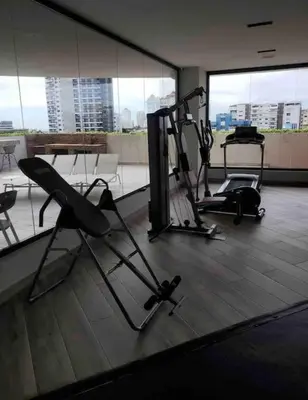 a gym with two exercise bikes in a room with windows at RoyalSuite 1BDR-Poll-Gym-Saune-g17 in Santo Domingo