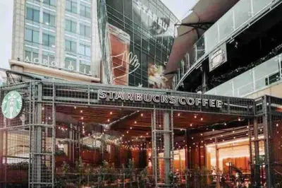 a store front of a building with a starbucks coffee sign at Suite Bolívar 3bdr - Pool - Cine -Saune - SPA- A8 in Santo Domingo