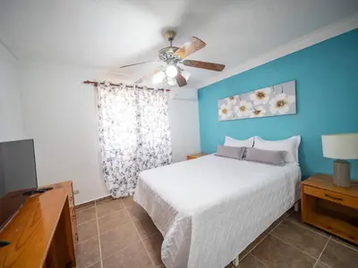 a bedroom with a bed and a ceiling fan at Garden Condos 10, 2br Apt In Sosua Strip in Sosúa