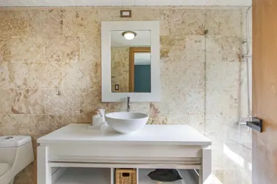 a bathroom with a sink and a mirror at Private Two-Storey Casa de Campo villa with pool, jacuzzi and golf cart in La Romana