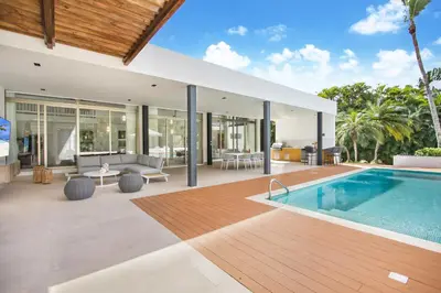 an exterior view of a house with a swimming pool at Private Two-Storey Casa de Campo villa with pool, jacuzzi and golf cart in La Romana