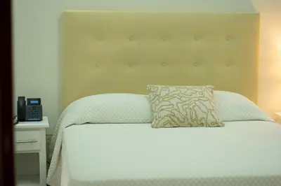 a bed with a pillow on top of it at Hotel Dominican Barcelona in SJM